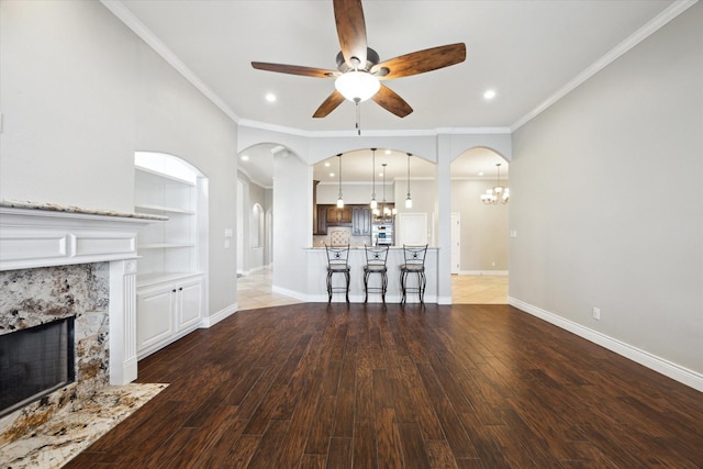 2508 Siskin Trl, League City, TX 77573 - living area featuring a chandelier, a fireplace, a ceiling fan, recessed lighting, and built in shelves