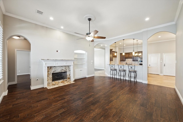 2508 Siskin Trl, League City, TX 77573 - unfurnished living room featuring ceiling fan, wood finished floors, a premium fireplace, recessed lighting, and crown molding