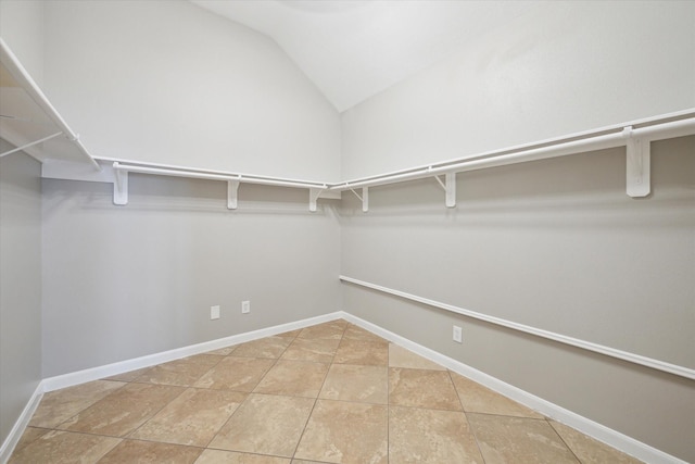 2508 Siskin Trl, League City, TX 77573 - spacious closet featuring vaulted ceiling and light tile patterned floors