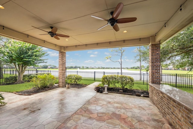 2508 Siskin Trl, League City, TX 77573 - fenced backyard featuring ceiling fan, a patio area, and a water view