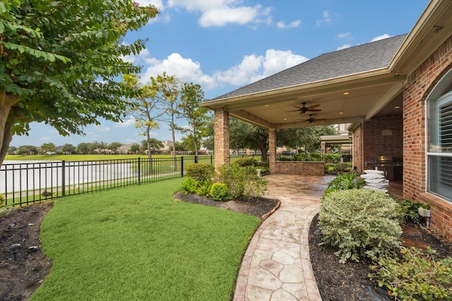 2508 Siskin Trl, League City, TX 77573 - view of yard featuring ceiling fan, a water view, and a patio area