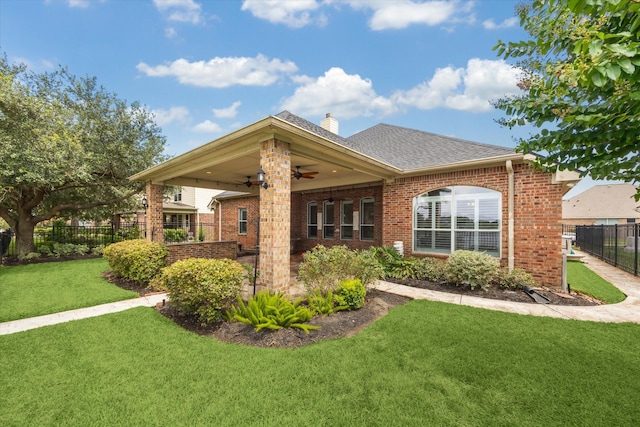 2508 Siskin Trl, League City, TX 77573 - rear view of property featuring ceiling fan, brick siding, a chimney, and a shingled roof