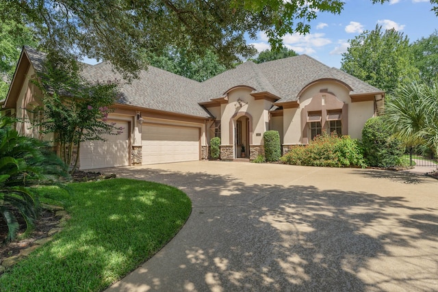 102 W Racing Cloud Ct, The Woodlands, TX 77381 - french country home featuring stucco siding, stone siding, driveway, and an attached garage