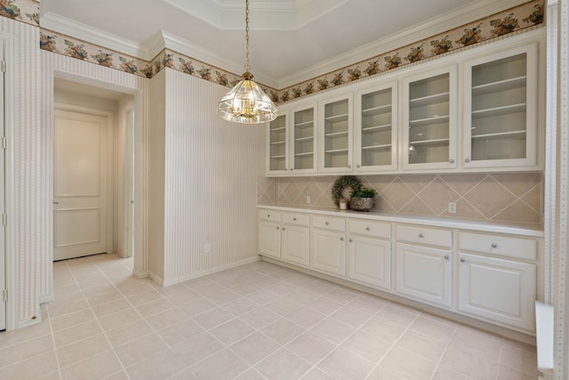 102 W Racing Cloud Ct, The Woodlands, TX 77381 - unfurnished dining area with a chandelier, light tile patterned flooring, and crown molding