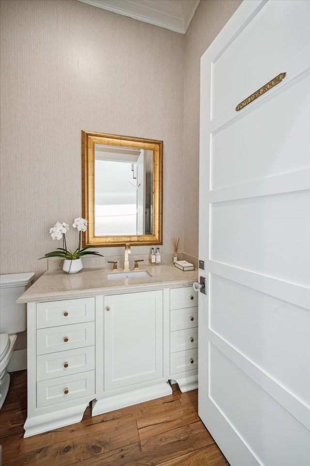 4223 Swashbuckle, Galveston, TX 77554 - bathroom featuring vanity, ornamental molding, wood finished floors, and wallpapered walls