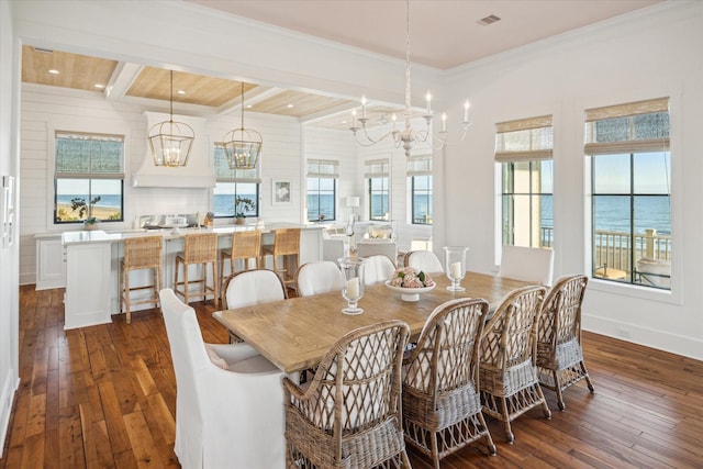 4223 Swashbuckle, Galveston, TX 77554 - dining space with a chandelier, dark wood-style flooring, healthy amount of natural light, beam ceiling, and crown molding