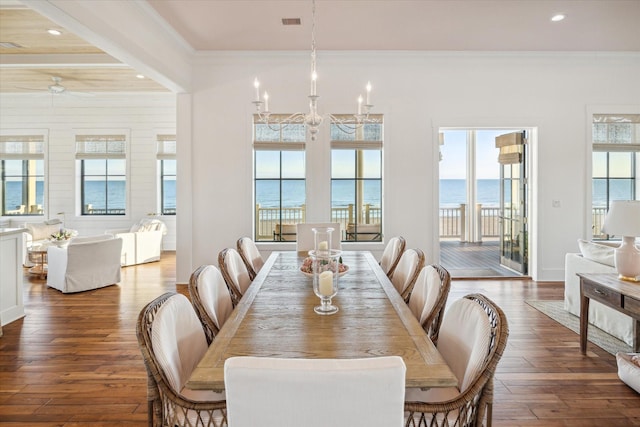 4223 Swashbuckle, Galveston, TX 77554 - dining area with hardwood / wood-style floors, crown molding, recessed lighting, and a water view