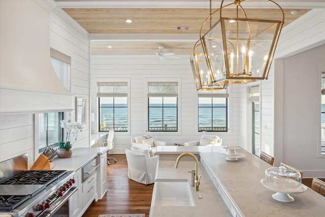 4223 Swashbuckle, Galveston, TX 77554 - kitchen featuring dark wood-type flooring, stainless steel range, custom exhaust hood, white cabinetry, and a ceiling fan