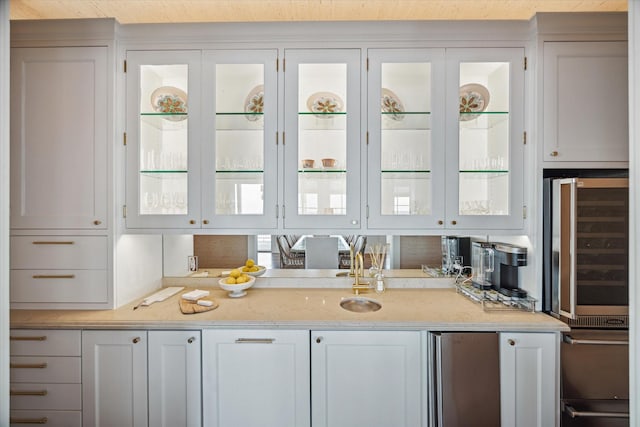 4223 Swashbuckle, Galveston, TX 77554 - kitchen featuring stainless steel fridge, glass insert cabinets, refrigerator, light stone countertops, and white cabinets