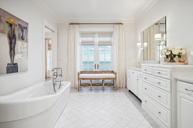 4223 Swashbuckle, Galveston, TX 77554 - bathroom featuring a soaking tub, ornamental molding, vanity, marble finish floors, and a water view