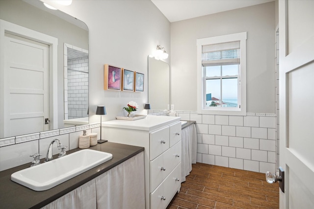 4223 Swashbuckle, Galveston, TX 77554 - full bath featuring tile walls, vanity, wood finished floors, and a wainscoted wall