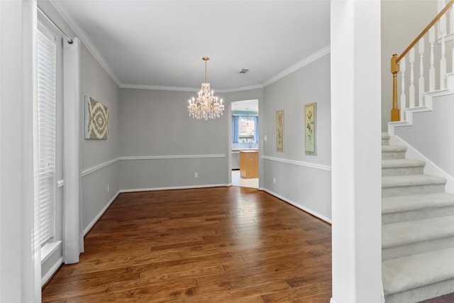 402 Starleaf Ln, Pearland, TX 77584 - unfurnished dining area with stairs, a chandelier, crown molding, and wood finished floors