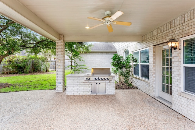 402 Starleaf Ln, Pearland, TX 77584 - fenced backyard with an outdoor kitchen, a patio area, and ceiling fan