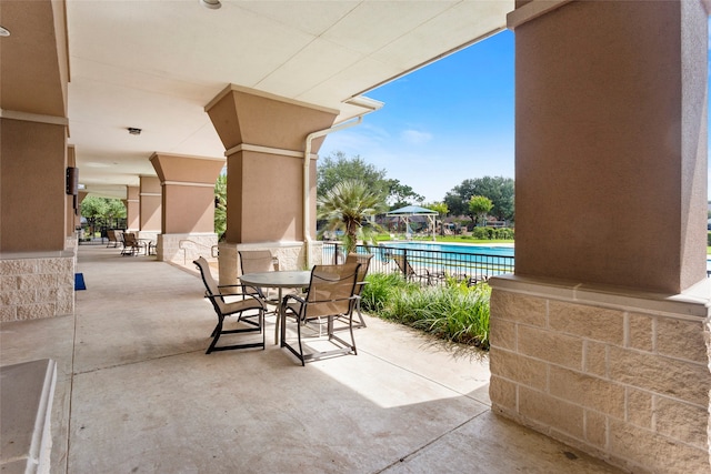 402 Starleaf Ln, Pearland, TX 77584 - view of patio featuring a community pool and outdoor dining space