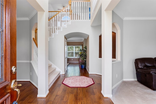 402 Starleaf Ln, Pearland, TX 77584 - entryway with arched walkways, stairs, wood finished floors, and ornamental molding