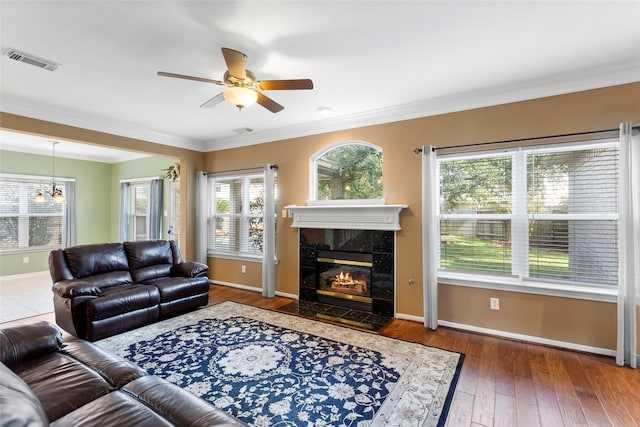 402 Starleaf Ln, Pearland, TX 77584 - living room with ceiling fan, ornamental molding, hardwood / wood-style flooring, and a high end fireplace
