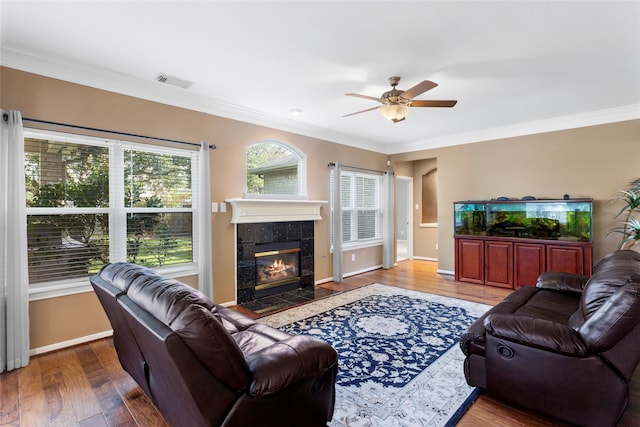 402 Starleaf Ln, Pearland, TX 77584 - living area with a ceiling fan, crown molding, plenty of natural light, wood finished floors, and a fireplace