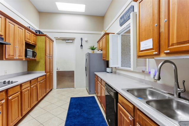 402 Starleaf Ln, Pearland, TX 77584 - kitchen with stainless steel appliances, light tile patterned floors, light countertops, and brown cabinets