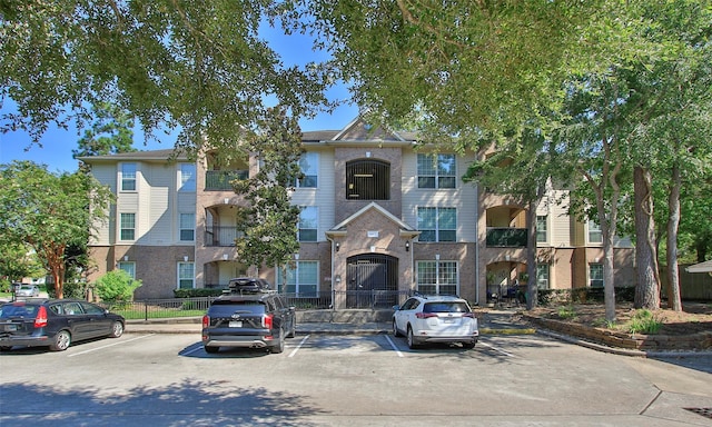 6607 Lake Woodlands Dr Unit 223, The Woodlands, TX 77382 - view of front of house featuring uncovered parking and brick siding