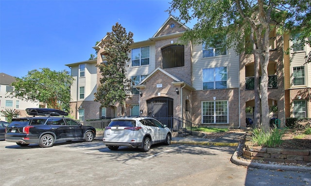 6607 Lake Woodlands Dr Unit 223, The Woodlands, TX 77382 - traditional home with brick siding and uncovered parking