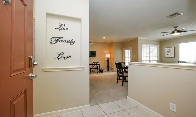 6607 Lake Woodlands Dr Unit 223, The Woodlands, TX 77382 - entryway with crown molding, light tile patterned flooring, a ceiling fan, and light colored carpet