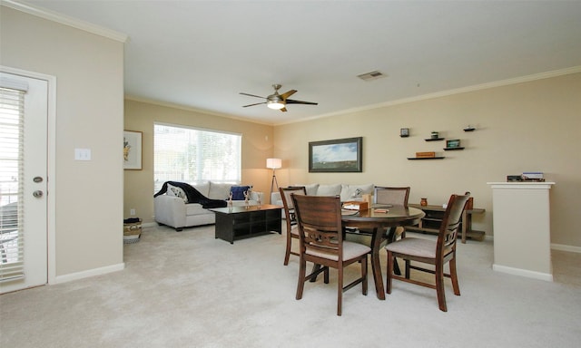 6607 Lake Woodlands Dr Unit 223, The Woodlands, TX 77382 - dining space featuring ceiling fan, crown molding, and light carpet