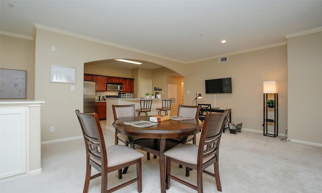 6607 Lake Woodlands Dr Unit 223, The Woodlands, TX 77382 - dining space featuring light colored carpet, crown molding, arched walkways, and recessed lighting
