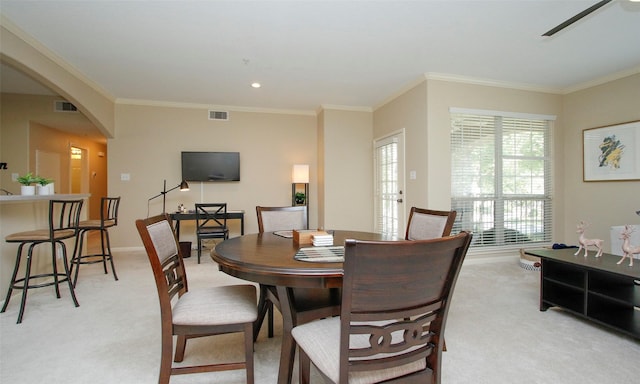 6607 Lake Woodlands Dr Unit 223, The Woodlands, TX 77382 - dining area with light colored carpet, arched walkways, crown molding, and ceiling fan