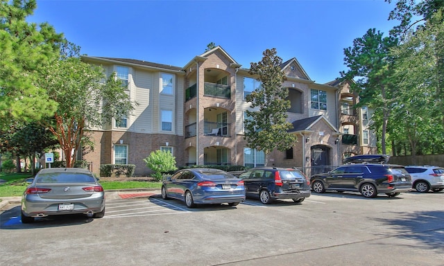 6607 Lake Woodlands Dr Unit 223, The Woodlands, TX 77382 - view of building exterior with uncovered parking