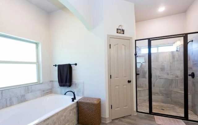 2977 Presidio Cir, Belton, TX 76513 - bathroom featuring a bath, a shower stall, and wood finished floors