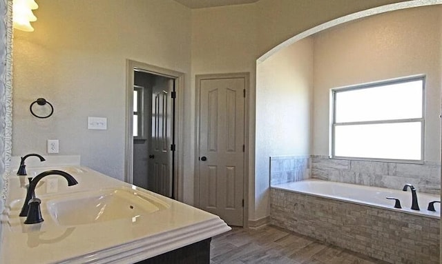 2977 Presidio Cir, Belton, TX 76513 - full bathroom with double vanity, a garden tub, and wood finished floors