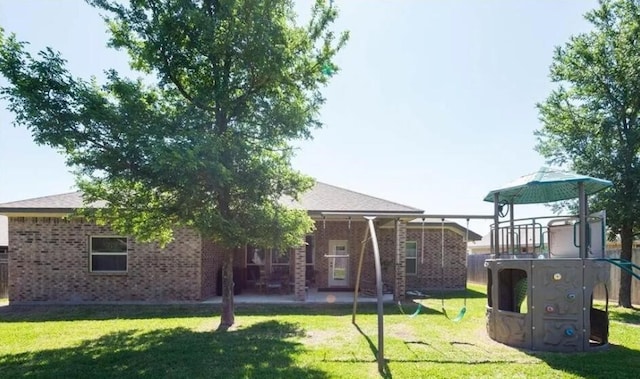 2977 Presidio Cir, Belton, TX 76513 - rear view of property with a playground, brick siding, a patio area, and a lawn