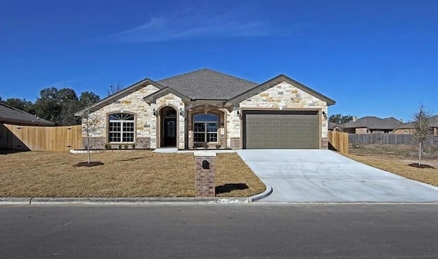 2977 Presidio Cir, Belton, TX 76513 - french provincial home featuring stone siding, concrete driveway, and a garage