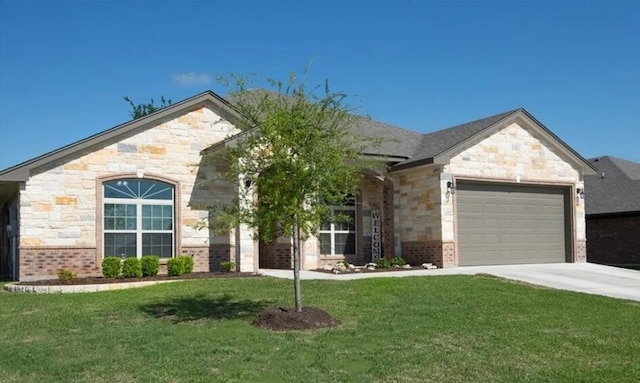 2977 Presidio Cir, Belton, TX 76513 - french country style house featuring an attached garage, a front lawn, driveway, and stone siding