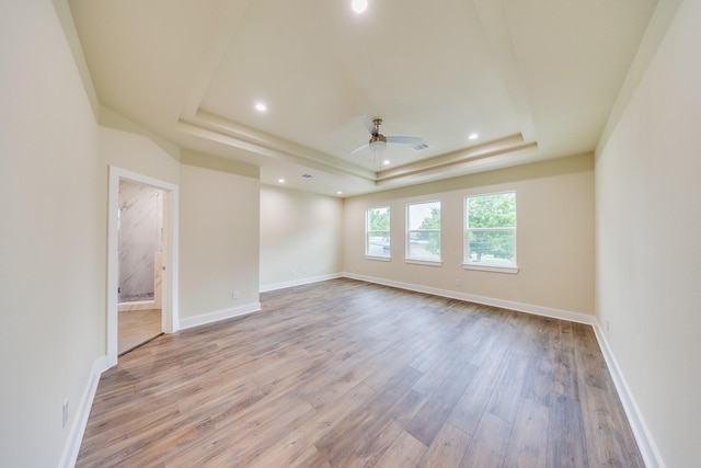 10512 Exeter St, Houston, TX 77093 - empty room with a tray ceiling, a ceiling fan, light wood-style flooring, and recessed lighting