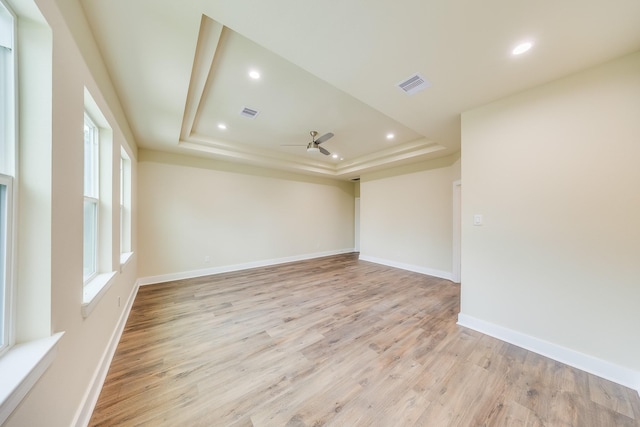 10512 Exeter St, Houston, TX 77093 - spare room featuring ceiling fan, a raised ceiling, light wood finished floors, and recessed lighting