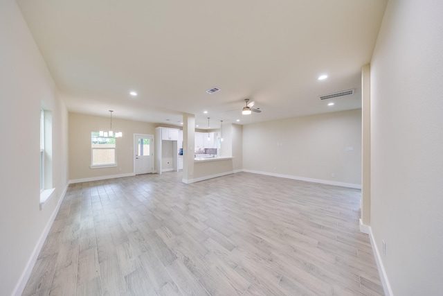 10512 Exeter St, Houston, TX 77093 - unfurnished living room with ceiling fan, light wood-style floors, recessed lighting, and a chandelier