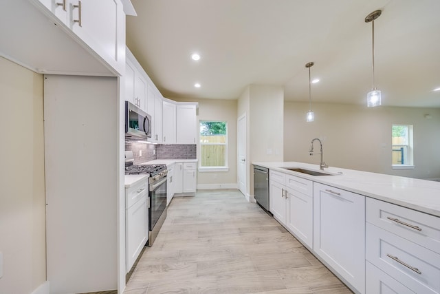 10512 Exeter St, Houston, TX 77093 - kitchen featuring stainless steel appliances, plenty of natural light, light countertops, backsplash, and recessed lighting