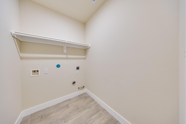 10512 Exeter St, Houston, TX 77093 - washroom with hookup for a gas dryer, electric dryer hookup, hookup for a washing machine, and light wood finished floors