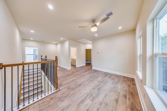 10512 Exeter St, Houston, TX 77093 - empty room featuring healthy amount of natural light, wood finished floors, a ceiling fan, attic access, and recessed lighting