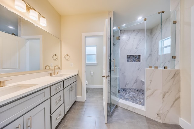 10512 Exeter St, Houston, TX 77093 - full bath with a marble finish shower, plenty of natural light, double vanity, and tile patterned floors