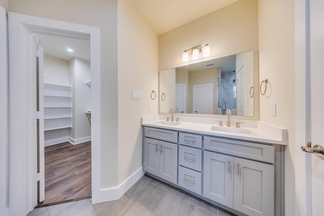 10512 Exeter St, Houston, TX 77093 - bathroom featuring double vanity, a shower, and wood finished floors