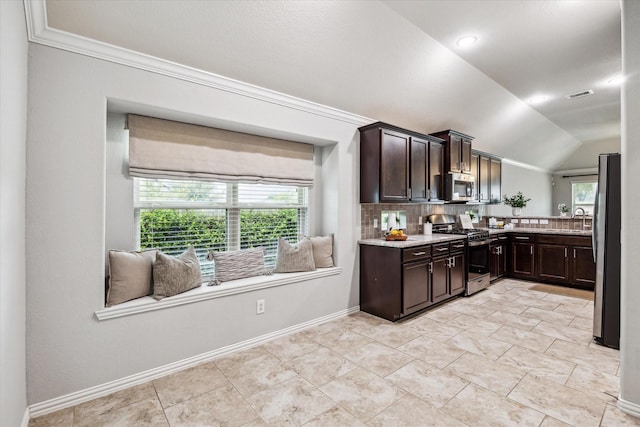 31703 Morning Ridge Ln, Spring, TX 77386 - kitchen with appliances with stainless steel finishes, dark brown cabinets, decorative backsplash, vaulted ceiling, and light stone countertops