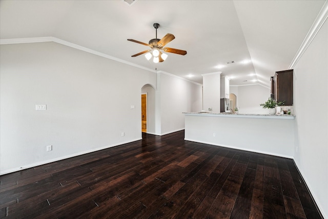 31703 Morning Ridge Ln, Spring, TX 77386 - unfurnished living room with arched walkways, dark wood-style floors, vaulted ceiling, ceiling fan, and ornamental molding
