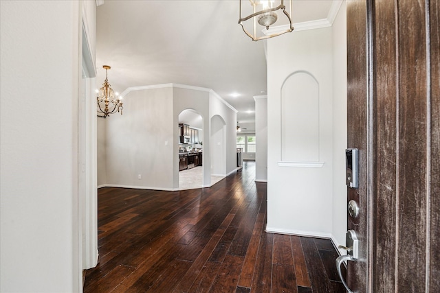 31703 Morning Ridge Ln, Spring, TX 77386 - foyer entrance featuring a chandelier, ornamental molding, wood-type flooring, and arched walkways