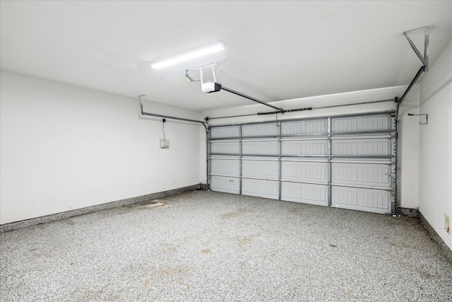 31703 Morning Ridge Ln, Spring, TX 77386 - garage featuring a garage door opener and baseboards