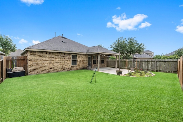31703 Morning Ridge Ln, Spring, TX 77386 - back of house featuring brick siding, a patio area, and a fenced backyard