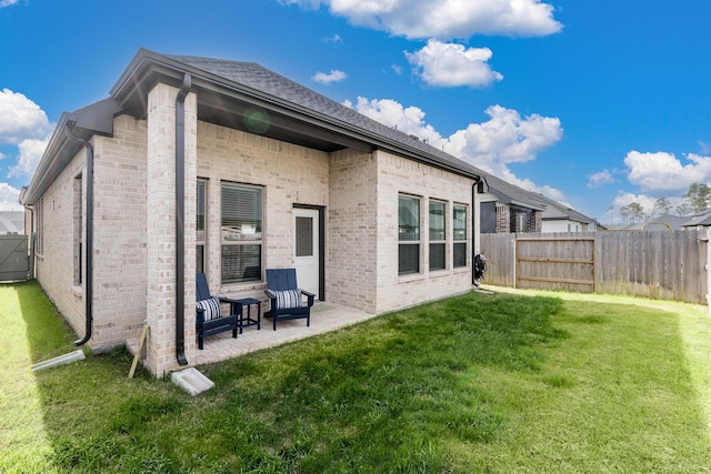 17746 Tree Of Heaven, Conroe, TX 77385 - rear view of house with brick siding, a fenced backyard, and a patio