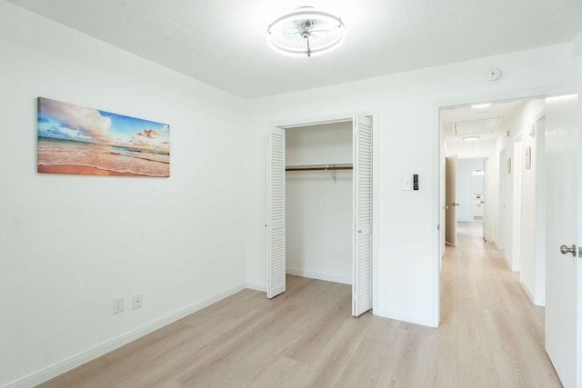 28926 Twisted Oak Dr, Shenandoah, TX 77381 - unfurnished bedroom with wood finished floors, attic access, and a closet
