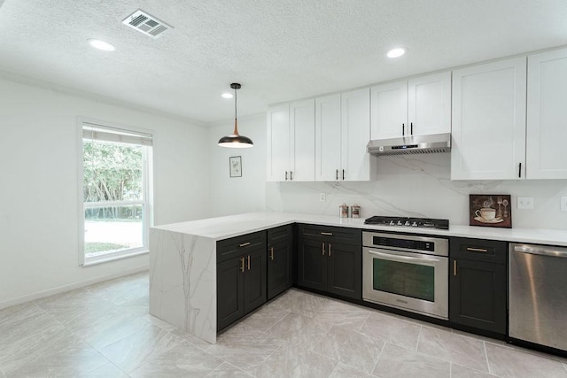 28926 Twisted Oak Dr, Shenandoah, TX 77381 - kitchen with appliances with stainless steel finishes, under cabinet range hood, white cabinetry, a peninsula, and recessed lighting